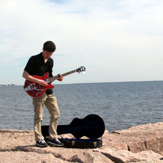 jim playing guitar beach